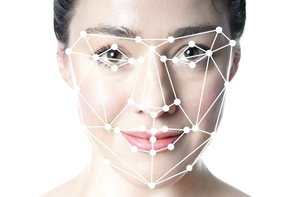 face detection or facial recognition grid overlay on face of young beautiful woman