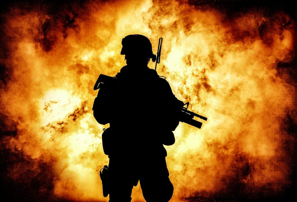 Soldiers silhouette on background of explosion
